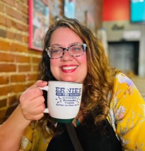  A woman smiles holding a coffee cup