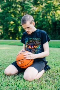 Young man sitting in grass